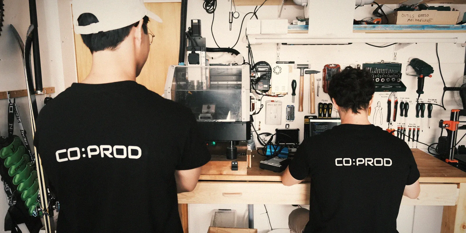 Two coprod team members working at the CNC in the workshop