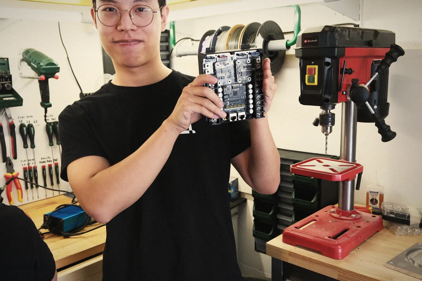A founder holding the co:system motherboard